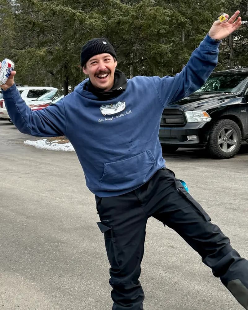 Slopestory founder Chad grinning with arms out after a day on the mountain